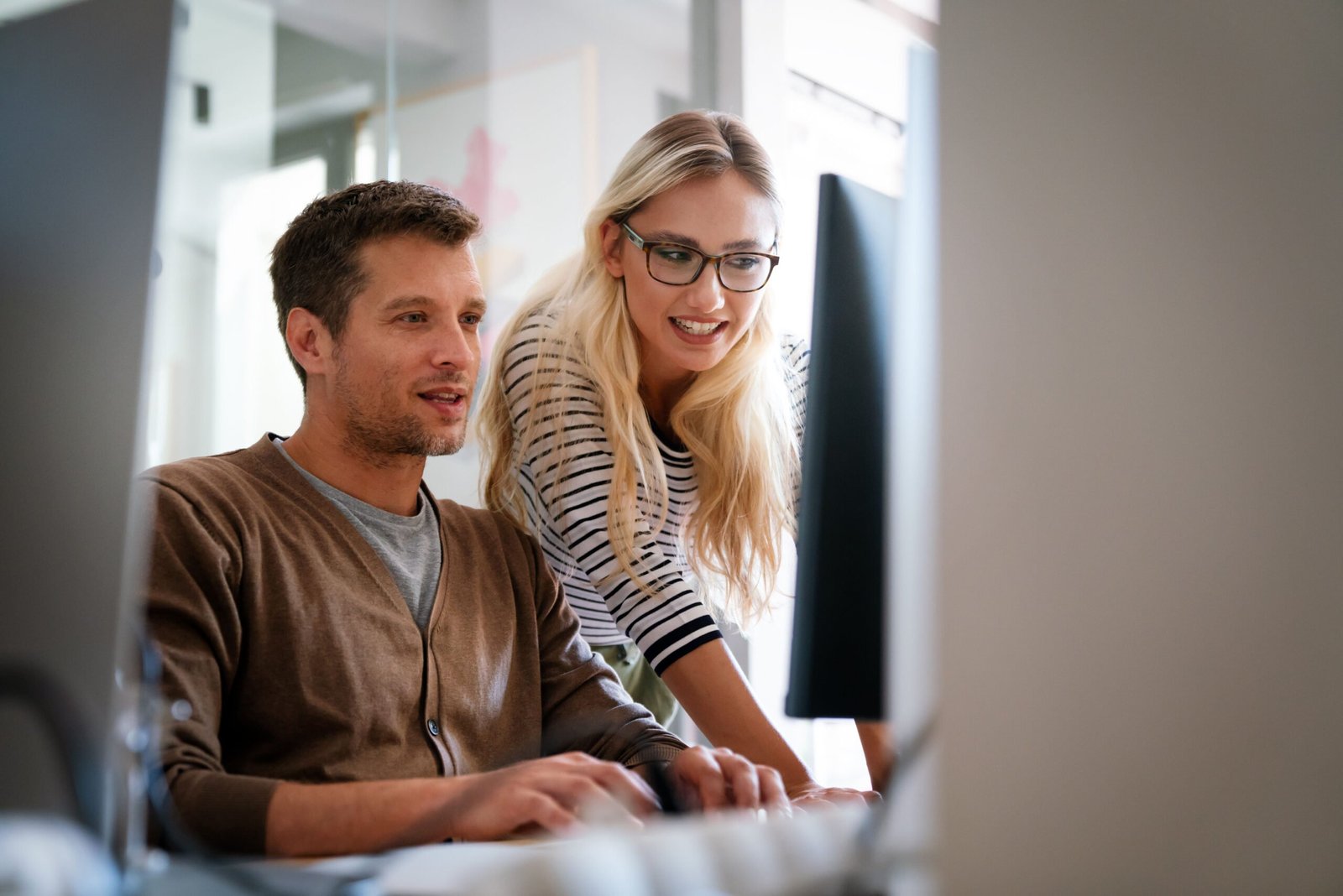 cost optimisation discussions between business owners in front of the computer